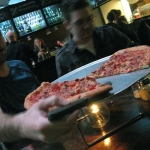 Everyone quickly digs into the pizza. We get our usual sausage and pepperoni. As you could tell, this is a large.