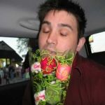 Brian samples the flowers he's bought for Jenny. Brian samples the flowers he's bought for Jenny.
