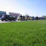 Across a field of green and below the Toyota sign, the MINIs await instruction. Across a field of green and below the Toyota sign, the MINIs await instruction.