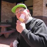 Dad attempts to shove the whole cone in his mouth. Dad attempts to shove the whole cone in his mouth.