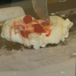 The ice cream and topping are mixed on the icy slab.