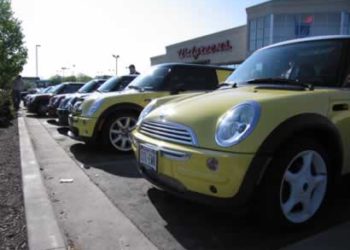 Bright one early Sunday morning, the MINIs meet under the Walgreens sign.