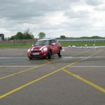 The object - drive backwards, then flip the car around 180 degrees on wet pavement and then drive forward back into line.