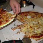 The crew ferociously digs into pepperoni and sausage pizza.