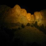 Mount Rushmore fully lit.