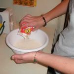 Emily pours in the essential cream.