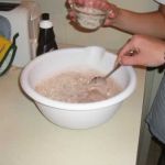 Jenni adds the malted milk ball bits. Emily stirs.